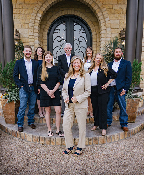 Julie Siddons Realtors team together outside a home, from the brokerage’s original photography